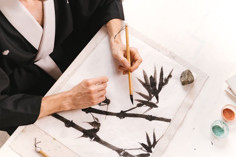 An Artist Using A Bamboo Brush In Painting