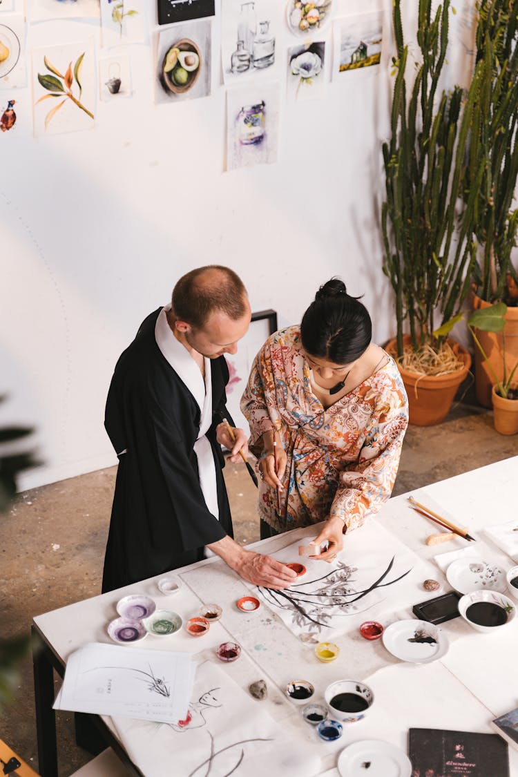 Woman And Her Teacher Practicing Calligraphy