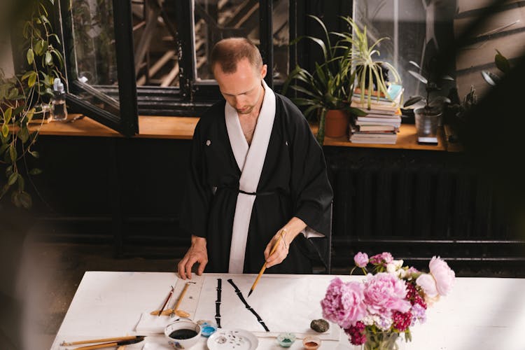 Man Painting In Workshop With Traditional Asian Technique