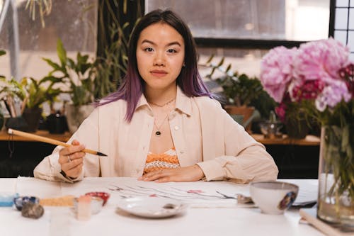 Girl in Beige Blazer Holding Paintbrush