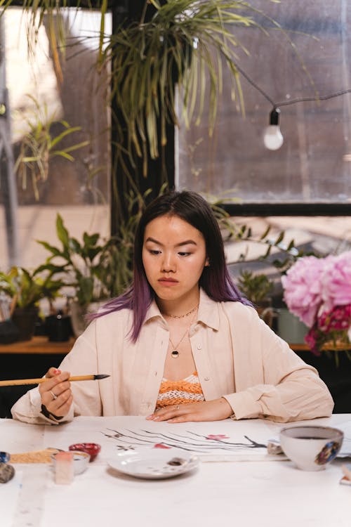 Woman in White Blazer Holding Paintbrush