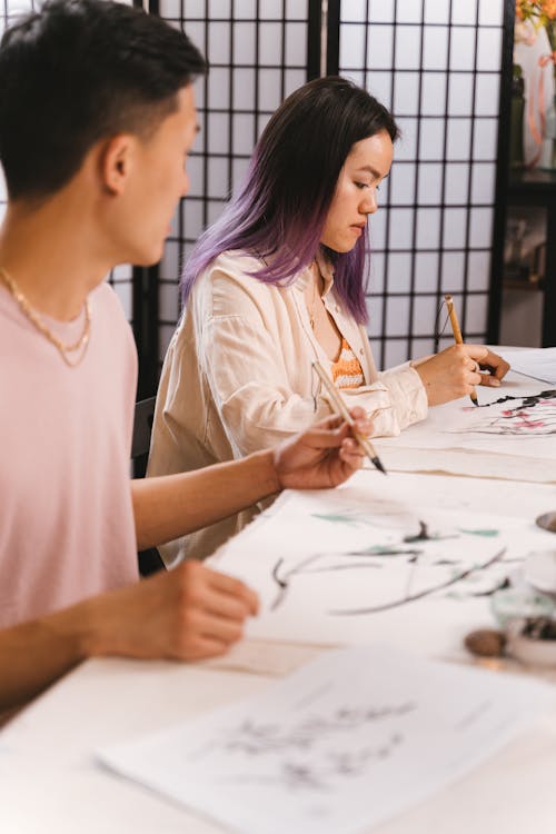 A Man and a Woman Painting Artworks