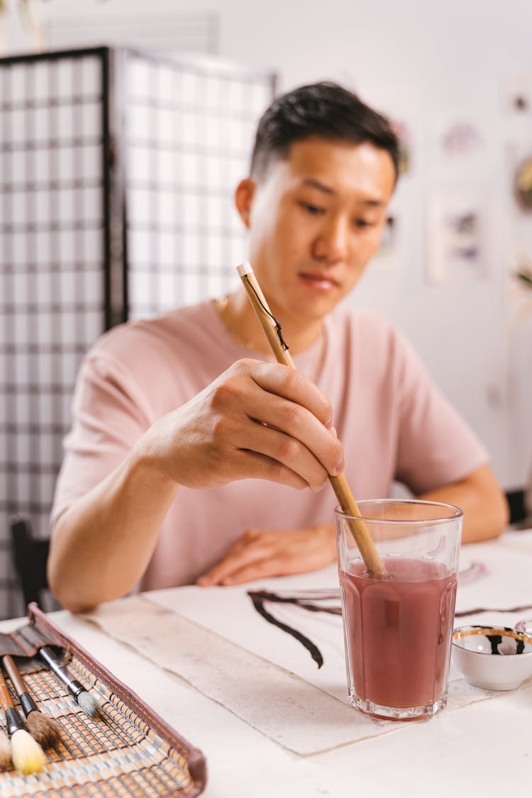 Man Dipping His Paintbrush Into Water