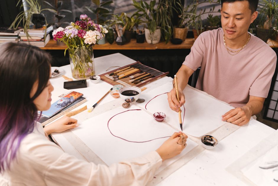A couple working on a shared hobby, perhaps painting a canvas together, symbolising collaboration and shared experiences. - couples therapy exercises for trust A couple working on a shared hobby, perhaps painting a canvas together, symbolising collaboration and shared experiences. - couples therapy exercises for trust