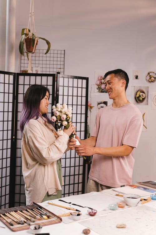 Man Giving His Girlfriend Bouquet of Flowers