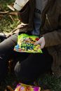 Person Holding Green and Yellow Plastic Pack