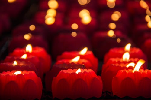 Red Candles With Lights during Night Time