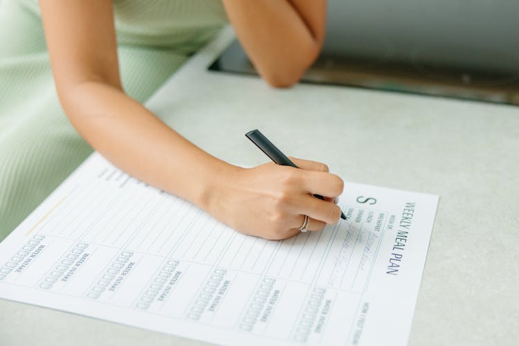 A Woman Making A Meal Plan