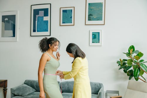 A Woman Measuring a Woman's Waist