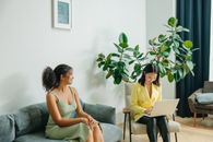 Woman in Gray Tank Top Sitting on Gray Couch