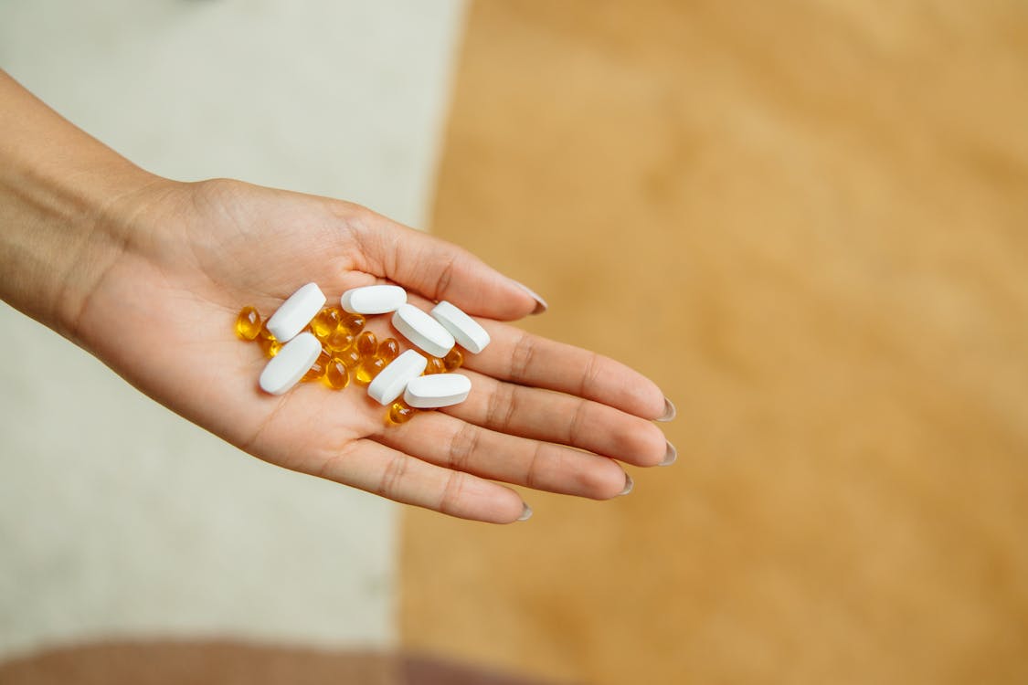Free Pills on a Person's Hand Stock Photo