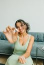 Woman in White Tank Top Sitting on Couch