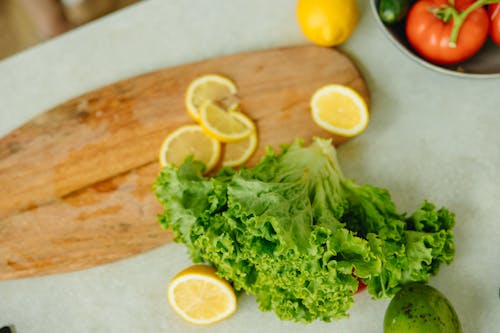 Close-Up Shot of Lettuce and Lemons on the Table
