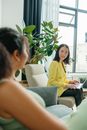 Woman in Yellow Shirt Sitting on Gray Couch