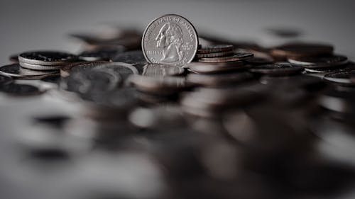 Silver Round Coins on Brown Wooden Surface