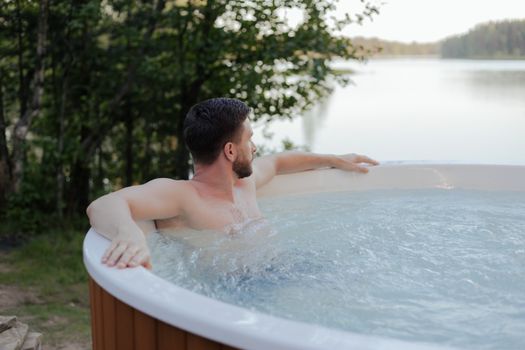 A Man relaxing while Swimming in Jacuzzi