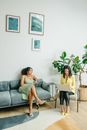 Woman in Yellow Shirt Sitting on Gray Couch