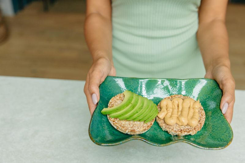 toast spread with hummus and topped with seasoning