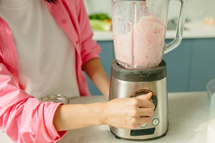 Hand Of A Person Operating A Blender