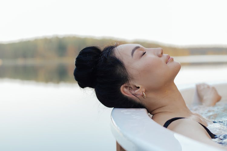 A Woman Relaxing In An Outdoor Jacuzzi