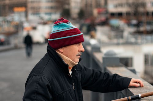 Man in Black Jacket and Red Knit Cap