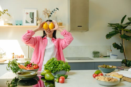 A Woman Holding Lemons Near Her Face