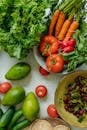 Carrots and Green Vegetable on Red Ceramic Plate