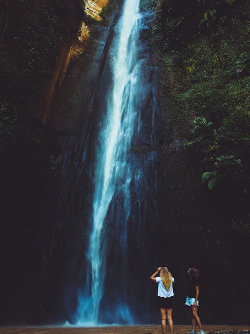 Two Women Near Waterfalls