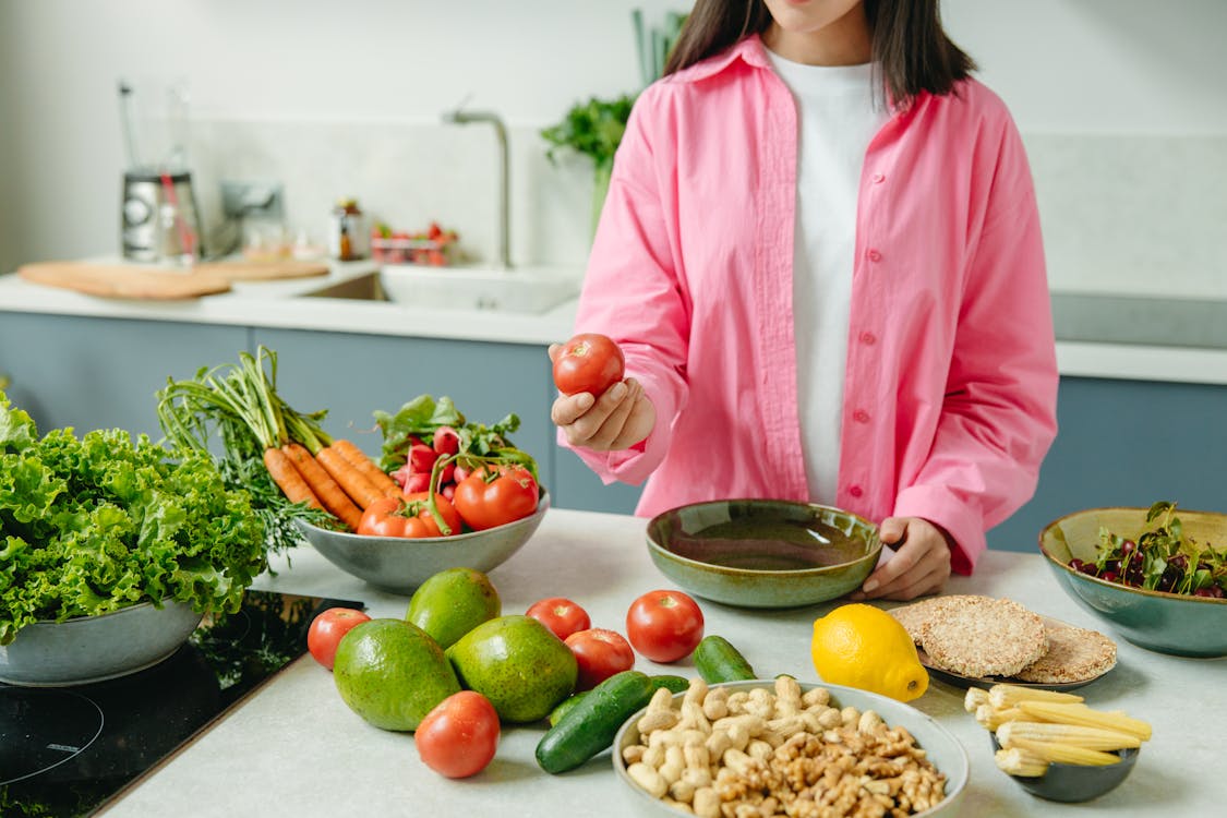 Free A Woman Holding a Red Tomato Stock Photo