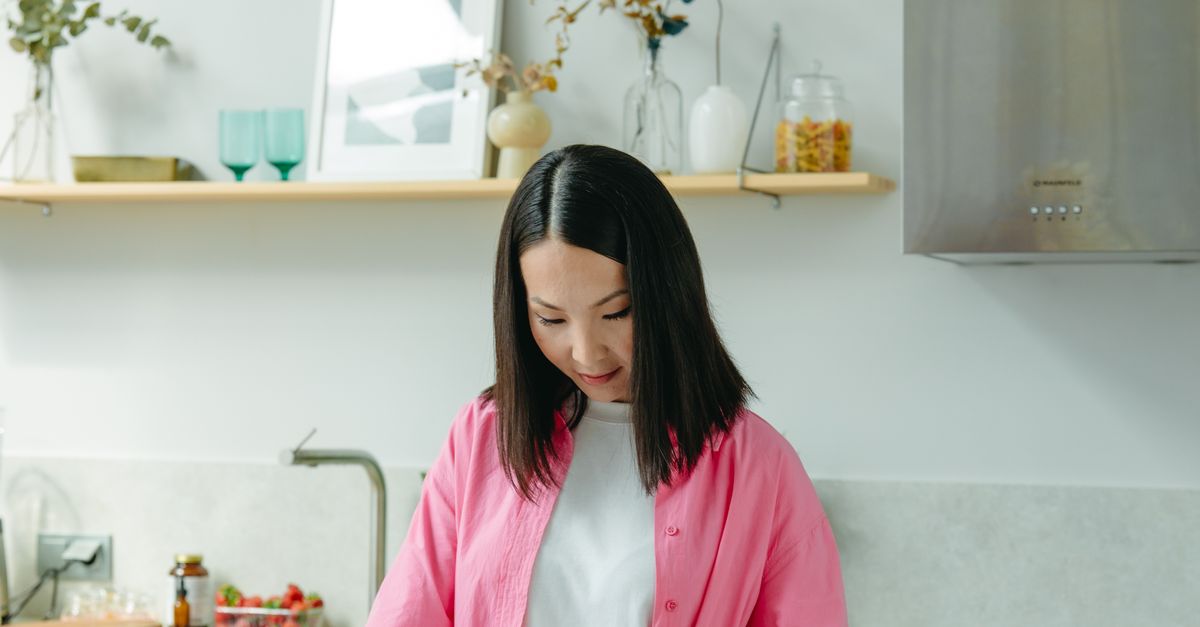 Woman Reading A Book On A Kitchen Counter Free Stock Photo woman-reading-a-book-on-a-kitchen-counter-free-stock-photo