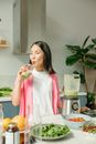 Woman in Pink Dress Holding Clear Drinking Glass