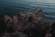 Brown Rock Formation Beside Body of Water
