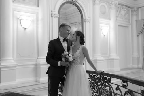Free A romantic black and white photo of a bride and groom embracing indoors at a wedding. Stock Photo