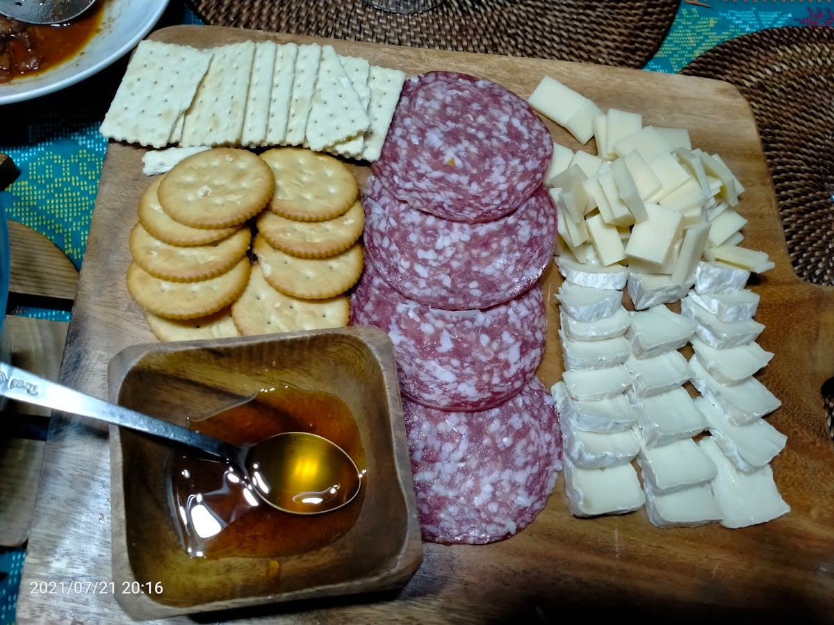 Assorted high-protein ingredients such as eggs, beans, salmon, nuts and cheese on a board