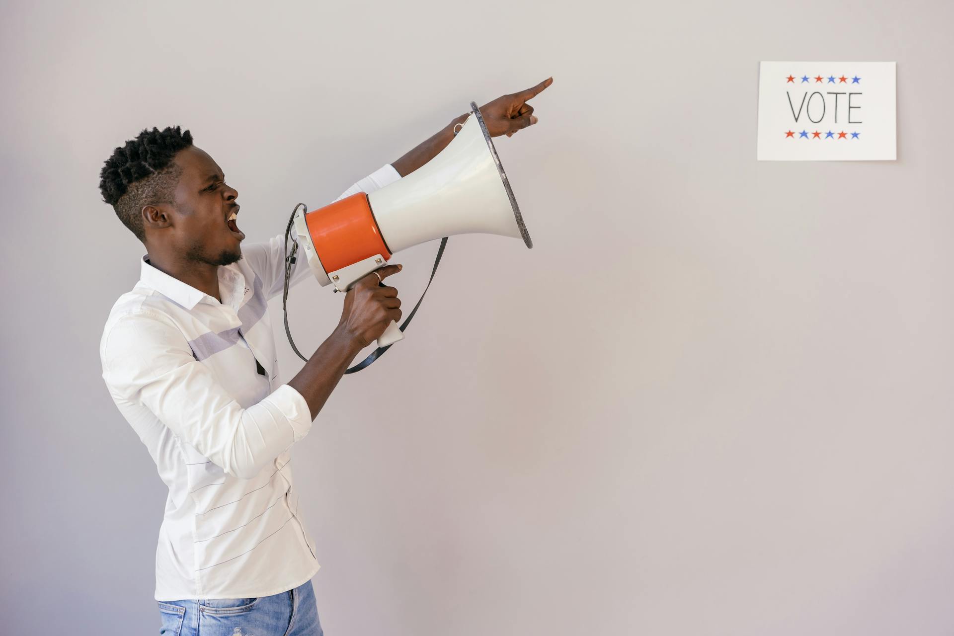 Man Pointing on Vote Signage