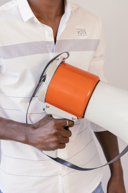 Free Close Up Photo of Person Holding Megaphone Stock Photo