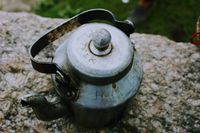 Rustic tea kettle on a stone surface — photo by Lunarly on Pexels