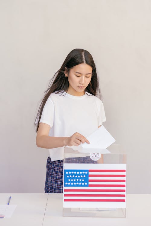 Woman Putting her Vote on Ballot Box