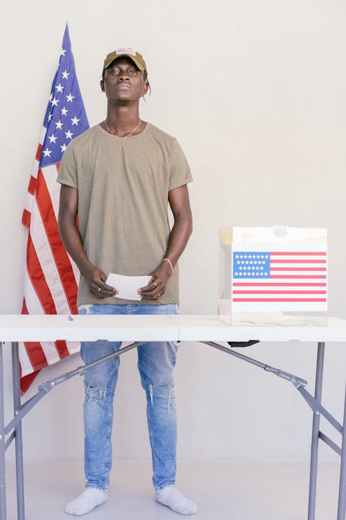 Man Standing Behind Table