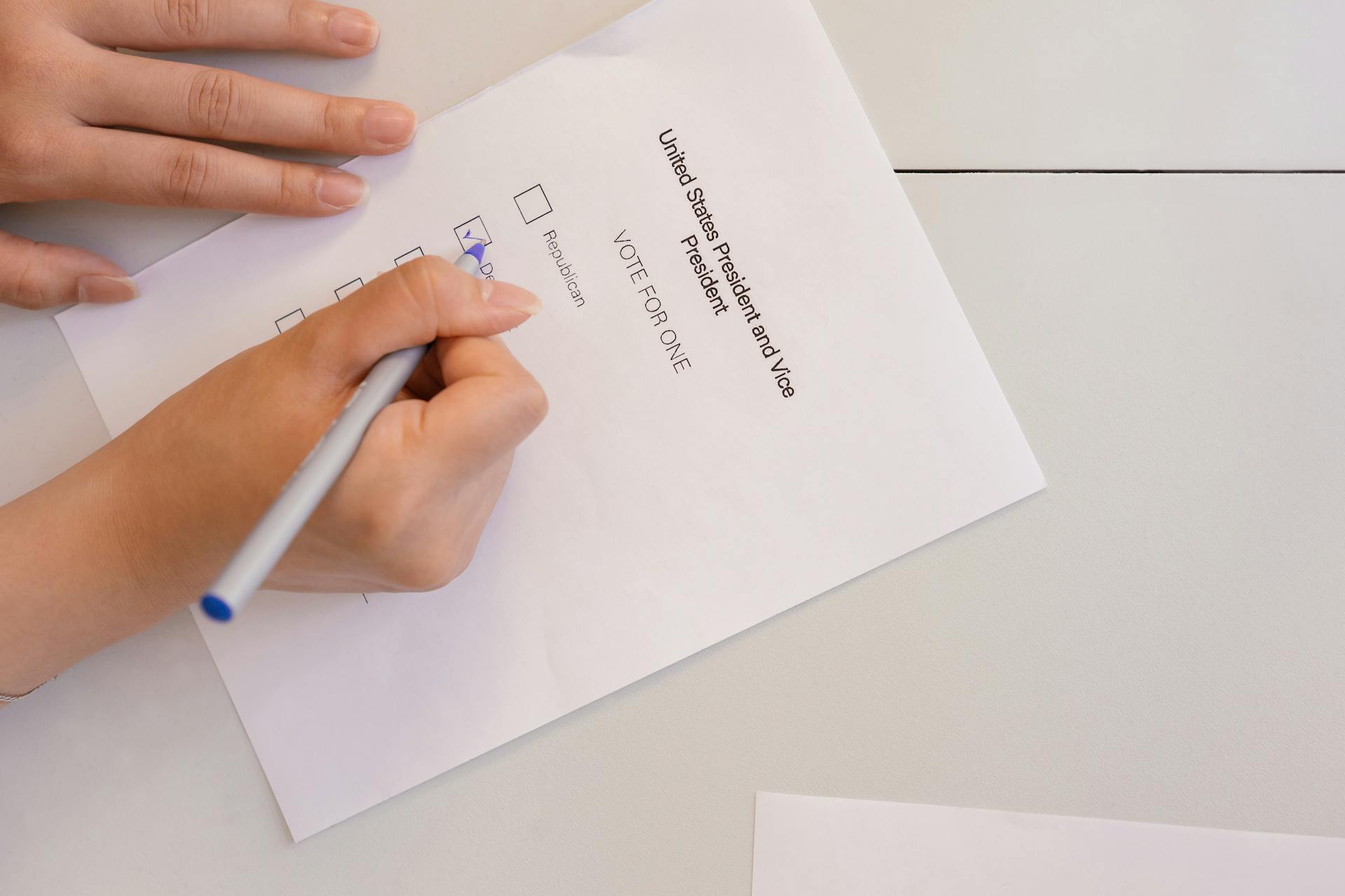 Person Selecting Votes on White Paper