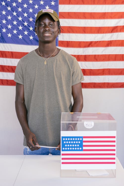 Man Standing Beside Ballot Box