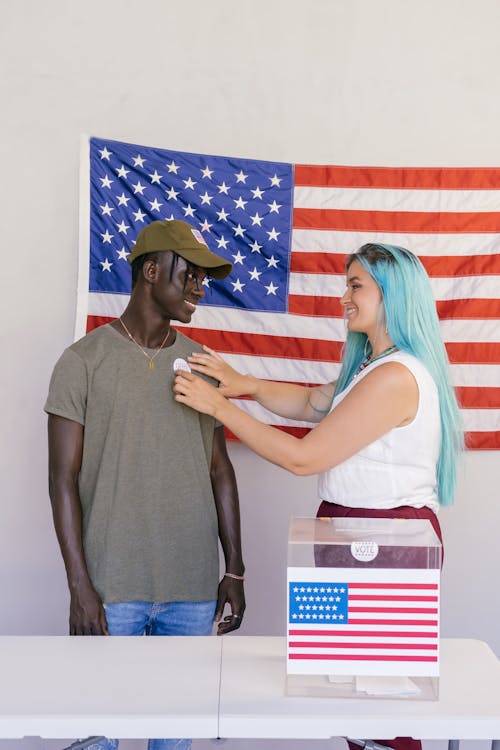 Woman Gives Man Voter's Badge