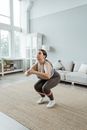 A Woman in Activewear Exercising at Home