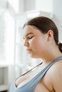Woman in Gray Tank Top Looking at the Window
