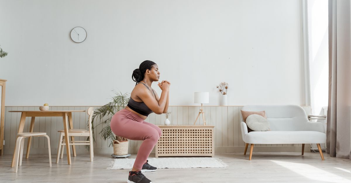 Glute training for women over 40 - Black woman doing a squat workout in the gym