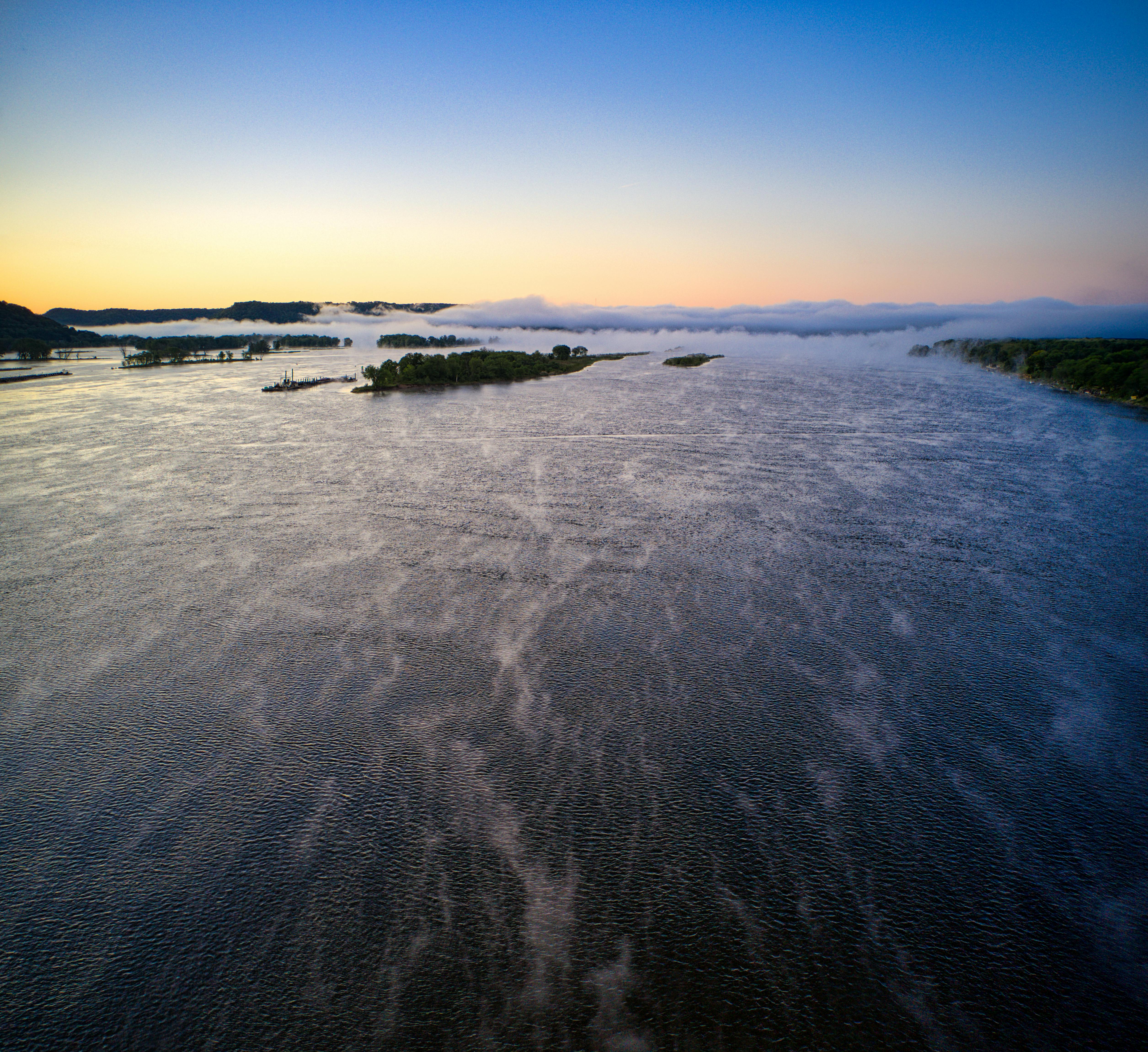 A serene Sunday morning view of the Volta River near Ho, mist rising over the water