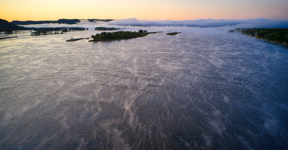 A serene Sunday morning view of the Volta River near Ho, mist rising over the water