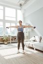 Woman in Gray Sports Bra and Black Shorts Doing Yoga