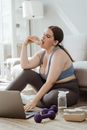 A Woman in Her Activewear Eating a Donut