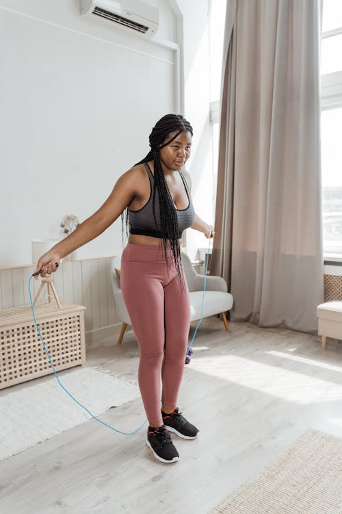 Woman Using Jump Rope in the Living Room